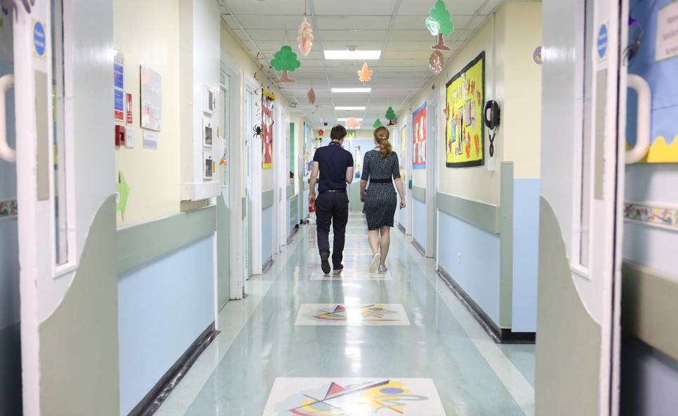 Two doctors walking down hospital corridor