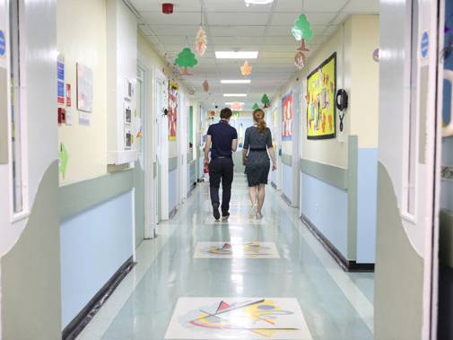 Two doctors walking down hospital corridor