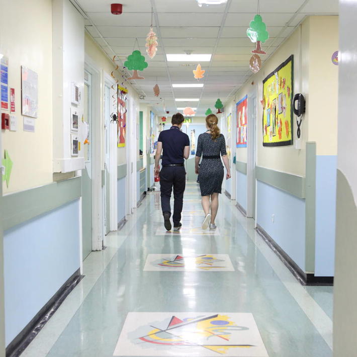 Two doctors walking down hospital corridor