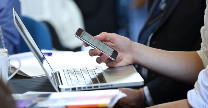 Laptop and mobile device at event