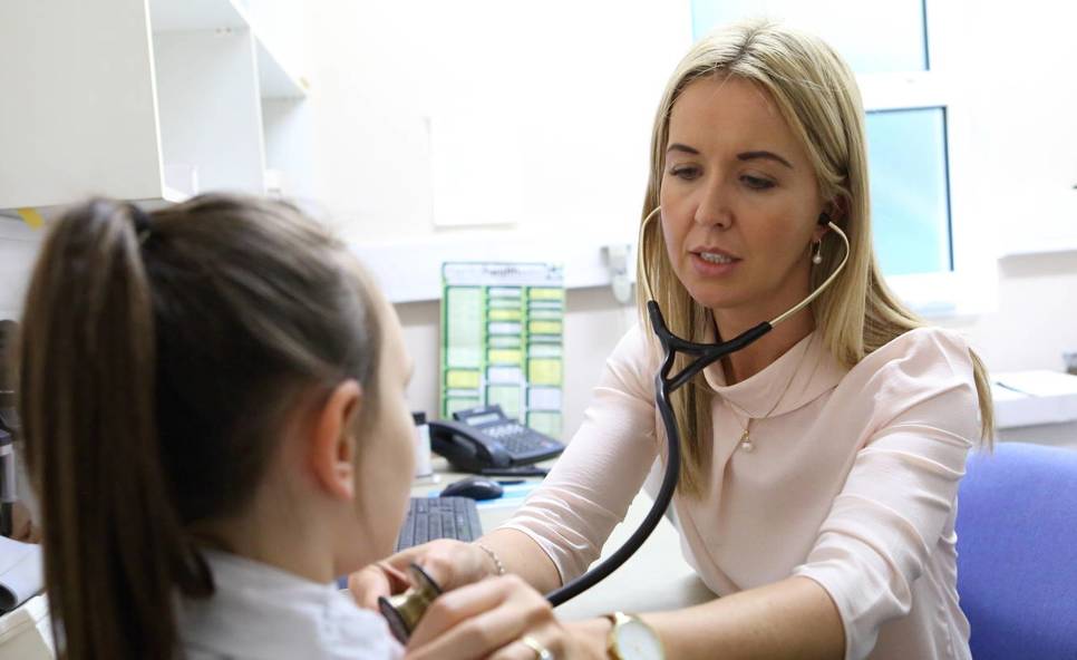 Female GP with child patient